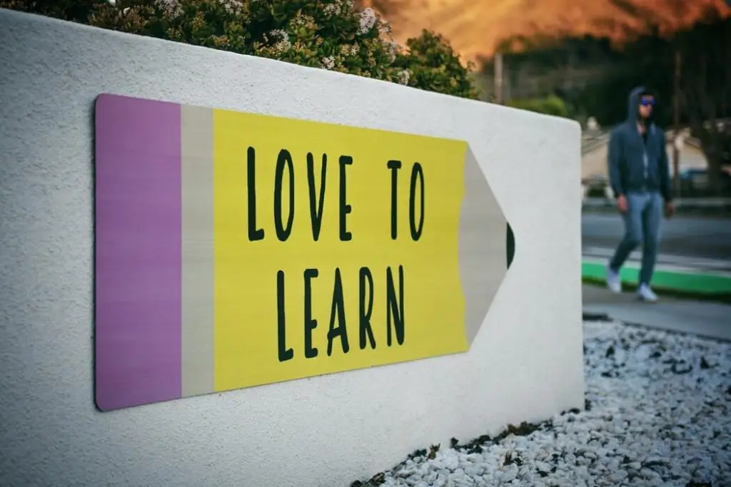 Sign with 'Love to Learn' on pencil shape.