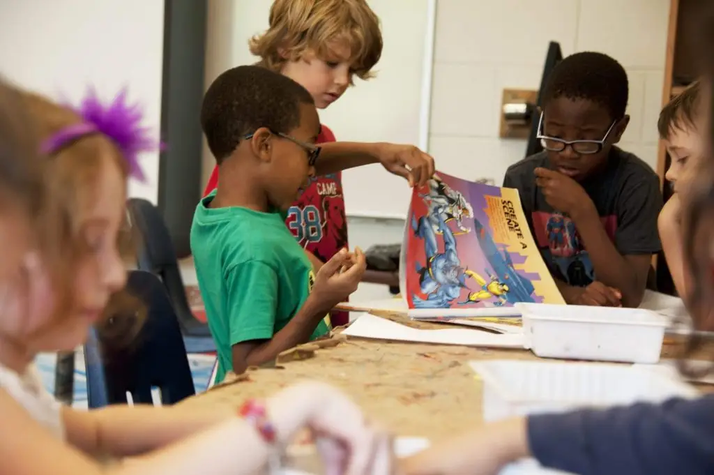 Children reading comic book in classroom