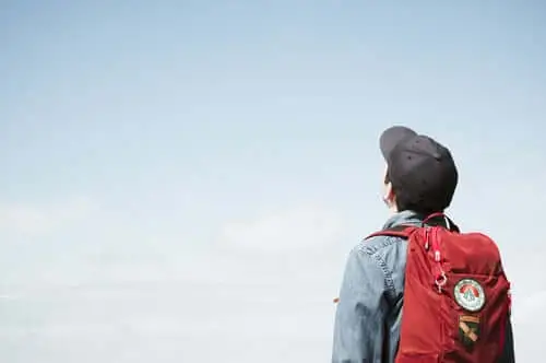 Person with backpack looking at the sky