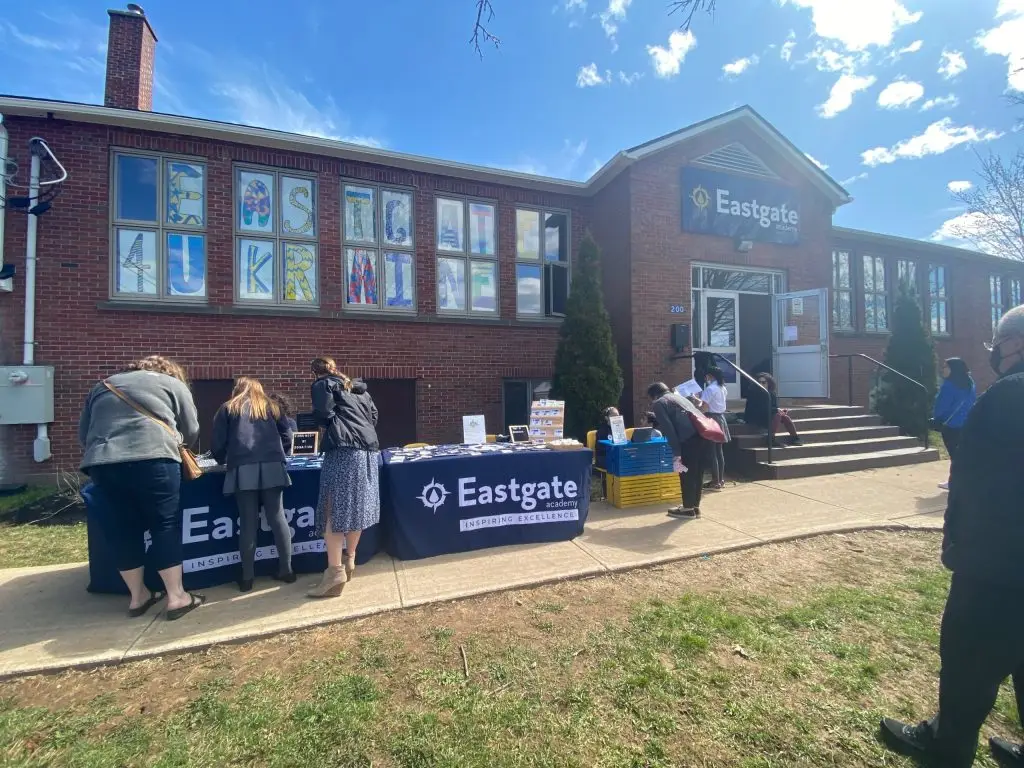 Eastgate Academy building with outdoor event tables.
