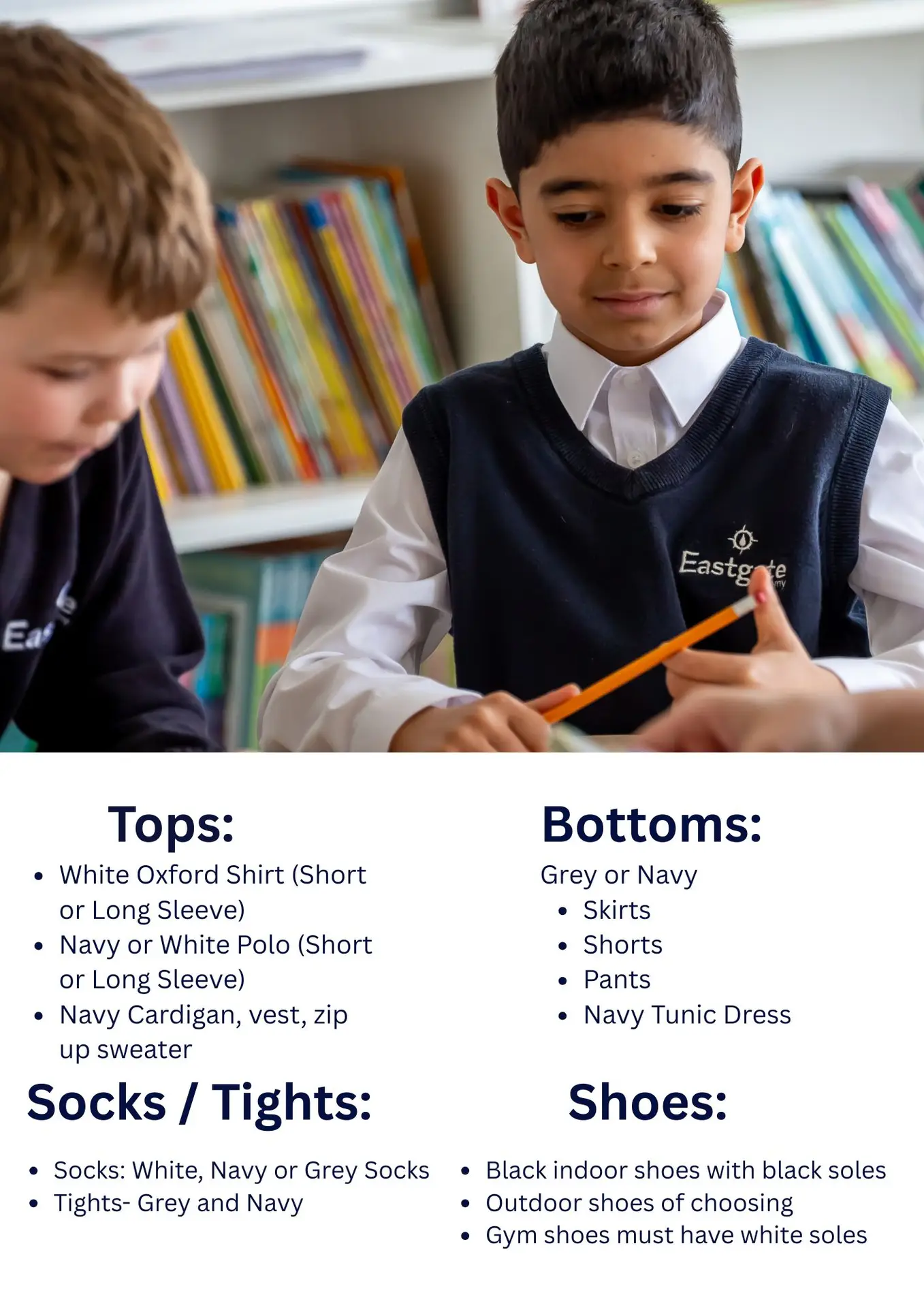 Two children in school uniforms reading together.