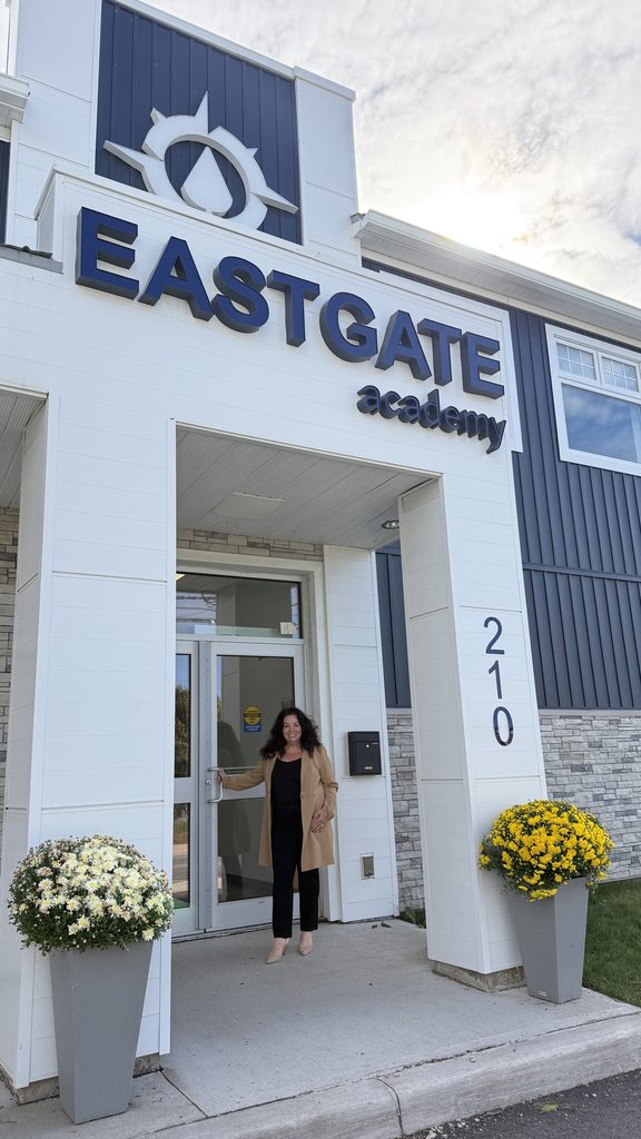 Woman standing outside East Gate Academy entrance